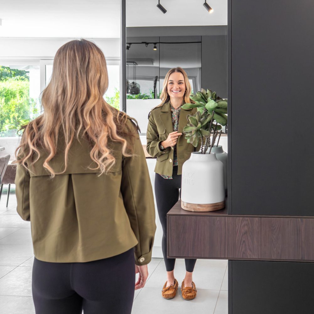 Maßgefertigte Garderobe im Flur mit seitlichem Spiegel und integrierter Kommode